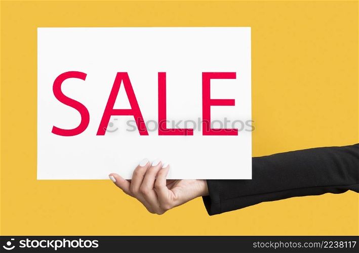 person holding black friday sale banner