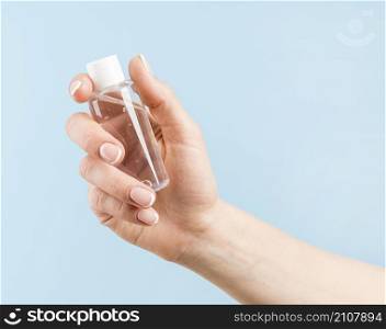 person holding disinfection bottle