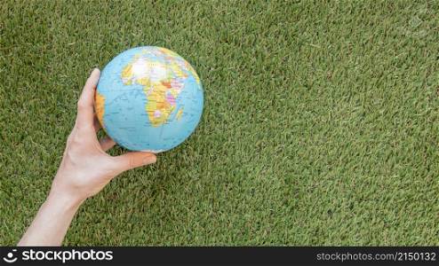 person holding globe grass with copy space