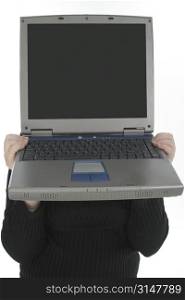 Person holding laptop in front of face.