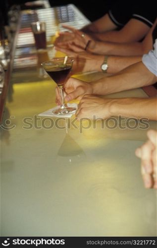 Person Holding Martini Glass