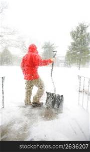 Person holding shovel in storm