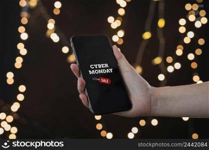 person holding smartphone with cyber monday inscription