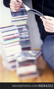 Person Listening to CD Collection