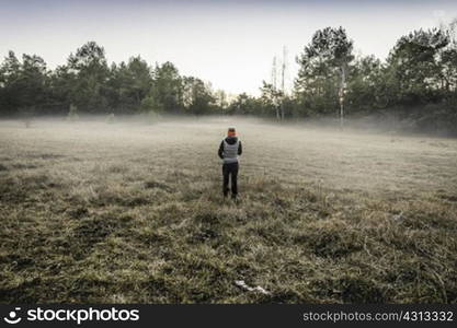 Person on misty open field, Augsburg, Bavaria, Germany