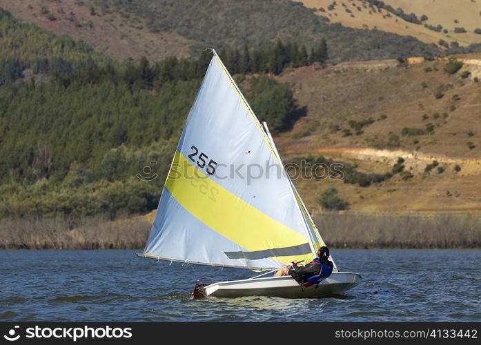 Person participating in a sailboat race