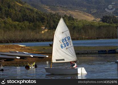 Person participating in a sailboat race