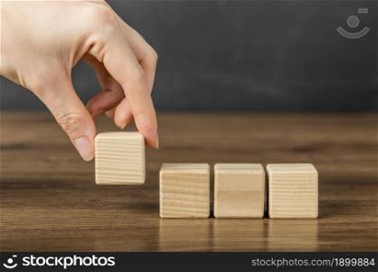 person placing wooden cube others. Resolution and high quality beautiful photo. person placing wooden cube others. High quality beautiful photo concept