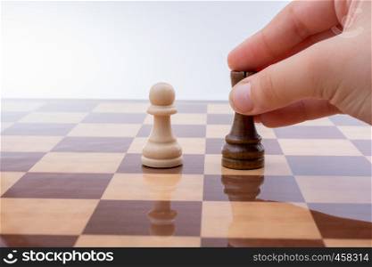 Person playing chess game making a move on board