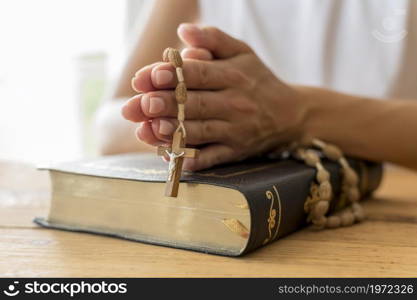 person praying with rosary holy book. High resolution photo. person praying with rosary holy book. High quality photo