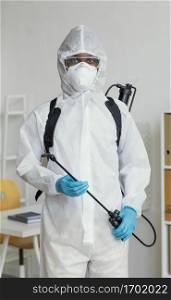 person protective suit getting ready disinfect room