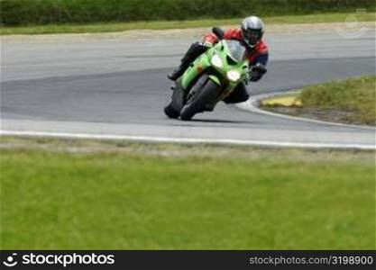 Person riding a motorcycle on a motor racing track