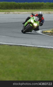 Person riding a motorcycle on a motor racing track