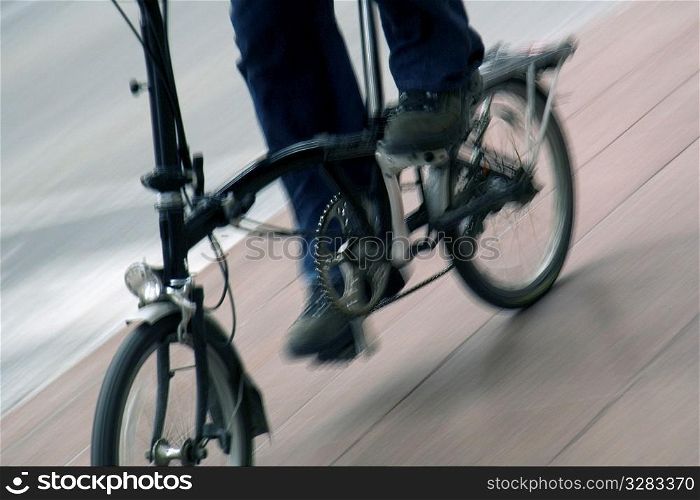 Person riding folding bicycle.