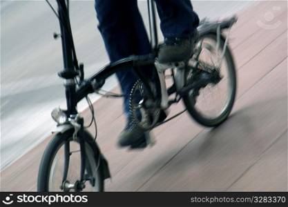 Person riding folding bicycle.