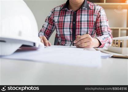 Person&rsquo;s engineer Hand Drawing Plan On Blue Print or working project in his office with architect equipment