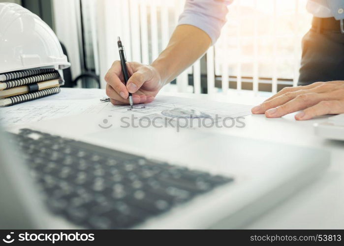 Person's engineer Hand Drawing Plan On Blue Print with architect equipment