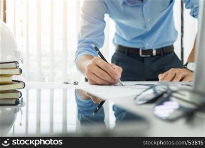 Person's engineer Hand Drawing Plan On Blue Print with architect equipment