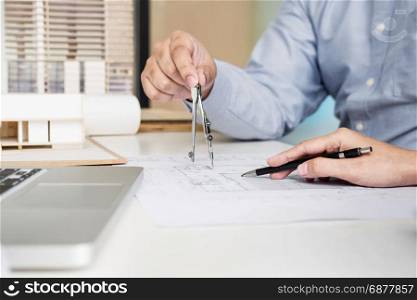 Person&rsquo;s engineer Hand Drawing Plan On Blue Print with architect equipment.