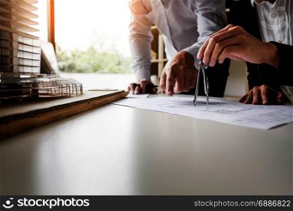 Person&rsquo;s engineer Hand Drawing Plan On Blue Print with architect equipment.