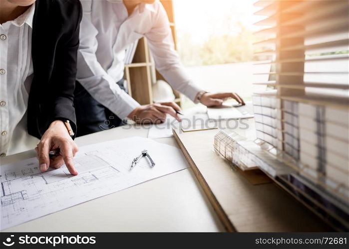 Person's engineer Hand Drawing Plan On Blue Print with architect equipment.