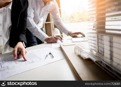 Person's engineer Hand Drawing Plan On Blue Print with architect equipment.
