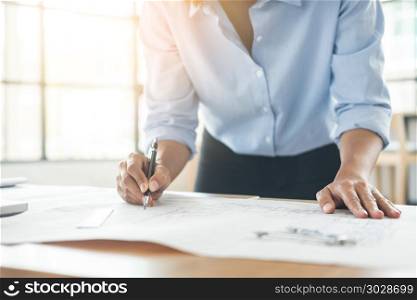 Person&rsquo;s engineer Hand Drawing Plan On Blue Print with architect equipment, Architects working at the table. Person&rsquo;s engineer Hand Drawing Plan On Blue Print with architect