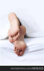 Person&rsquo;s foot in bed