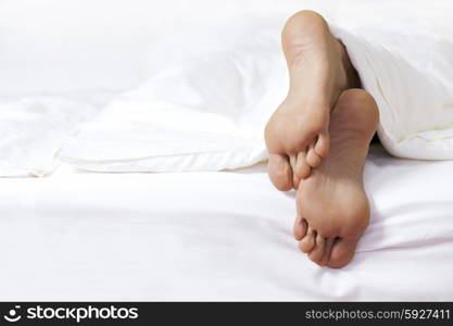 Person&rsquo;s foot in bed