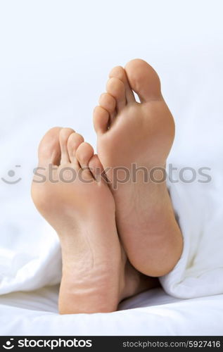 Person&rsquo;s foot in bed, close-up