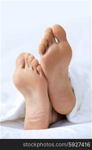 Person&rsquo;s foot in bed, close-up