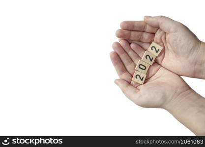 Person&rsquo;s hand holding 2022 on white background top view a minimal concept with copy space. Happy new year space for text. Person&rsquo;s hand holding 2022 on white background top view a minimal concept with copy space. Happy new year