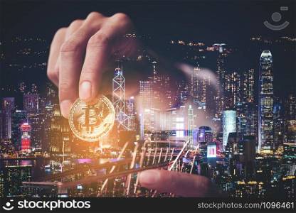 Person&rsquo;s Hand With Bitcoin, Business Finance concept, Double exposure with city