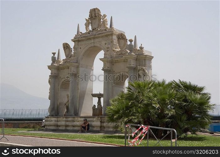 Person sitting in front of a fountain, La Fontana dell&acute;Immacolatella, Naples, Naples Province, Campania, Italy