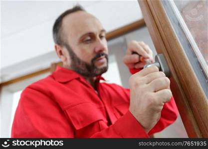 person tightening a screw with a screwdriver