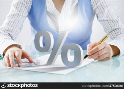 Person using magnifier for exploration. Close view of businesswoman looking at percentage sign with magnifier