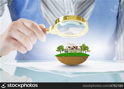 Person using magnifier for exploration. Woman botanist checking green ecology concept with magnifying glass