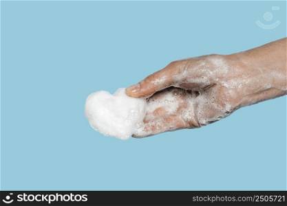 person washing hands with white soap