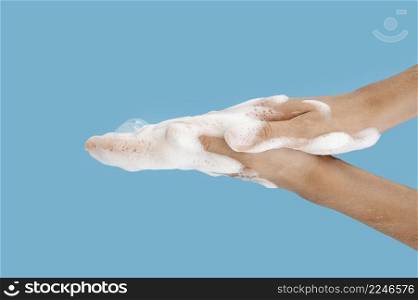 person washing its hands blue background