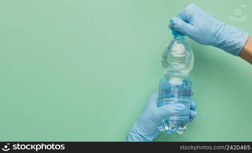 person wearing gloves opening bottle