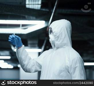 person wearing prevention suit taking samples