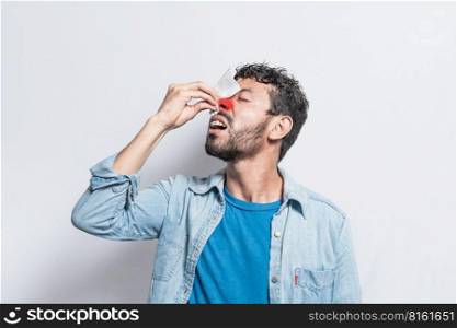 Person with irritated nose on isolated background, man with red nose cold, concept of person with sinusitis, Person with nasal congestion