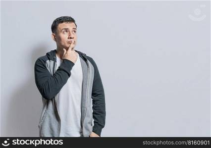 Person wondering with hand on chin isolated, Thoughtful person rubbing his chin, Concept of wondering man with doubt face