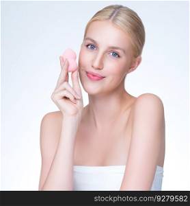 Personable beautiful natural soft makeup woman using powder puff for facial makeup concept. Cushion foundation applying on young girl face in isolated background.. Personable beautiful natural makeup woman using powder puff for facial makeup.