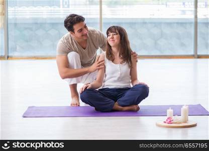 Personal coach helping during yoga session