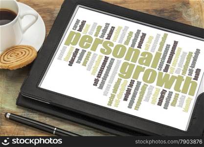 personal growth word cloud on a digital tablet with a cup of coffee