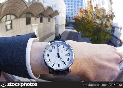 Personal perspective of businessman looking at his watch