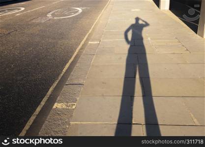 Personal perspective shadow of a man scratching his head at sunset leaving the office