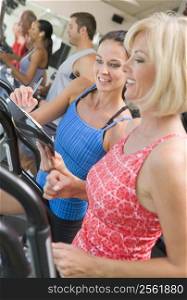 Personal Trainer Instructing Woman On Treadmill
