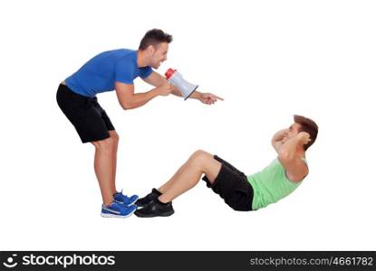 Personal trainer with a megaphone and boy making abdominal isolated on a white background